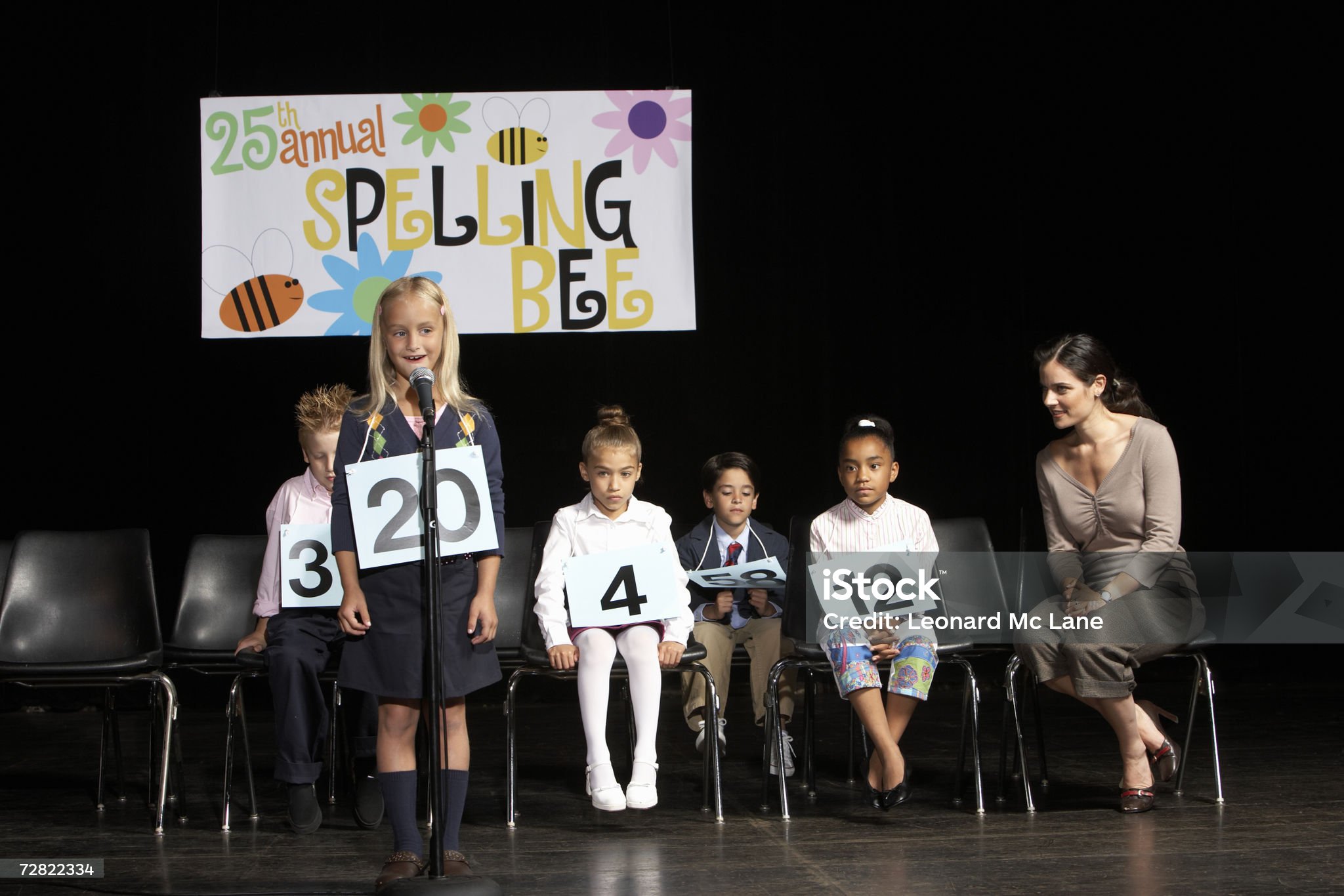 Girl (6-7) performing at spelling bee competition